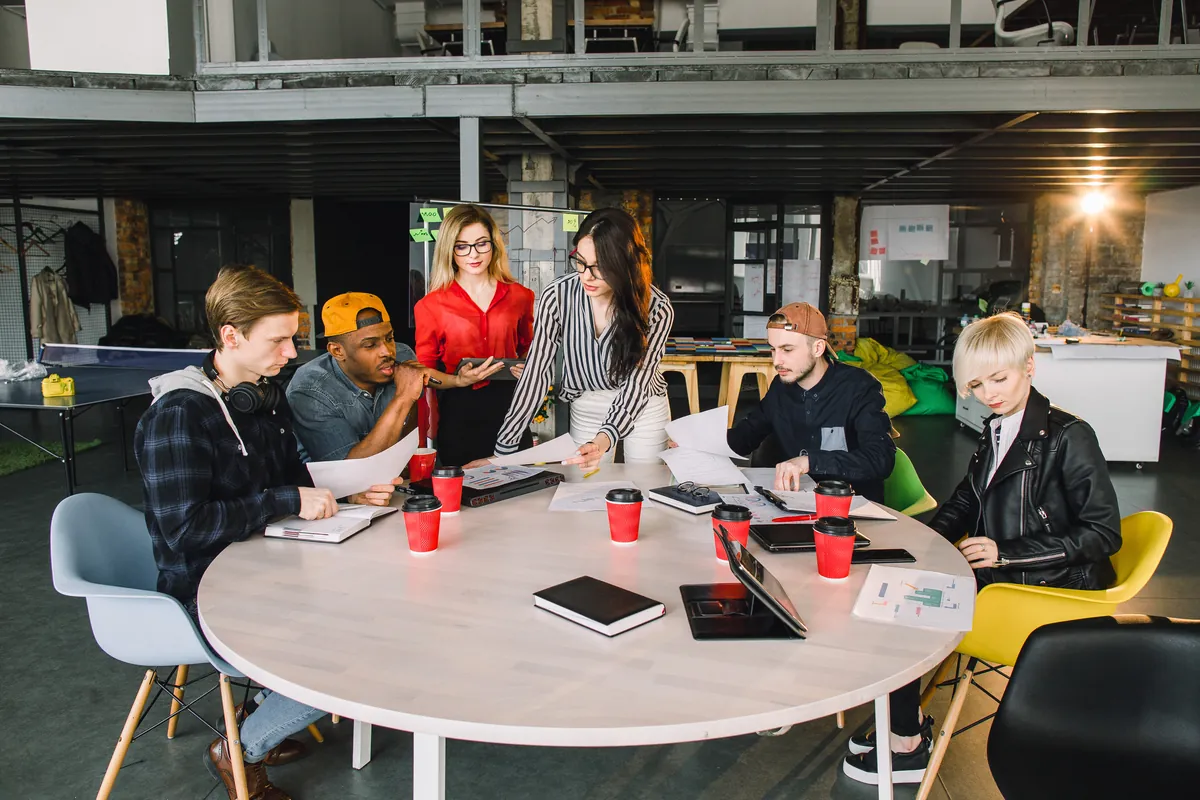 A team of colleagues reviewing documents together around a round table